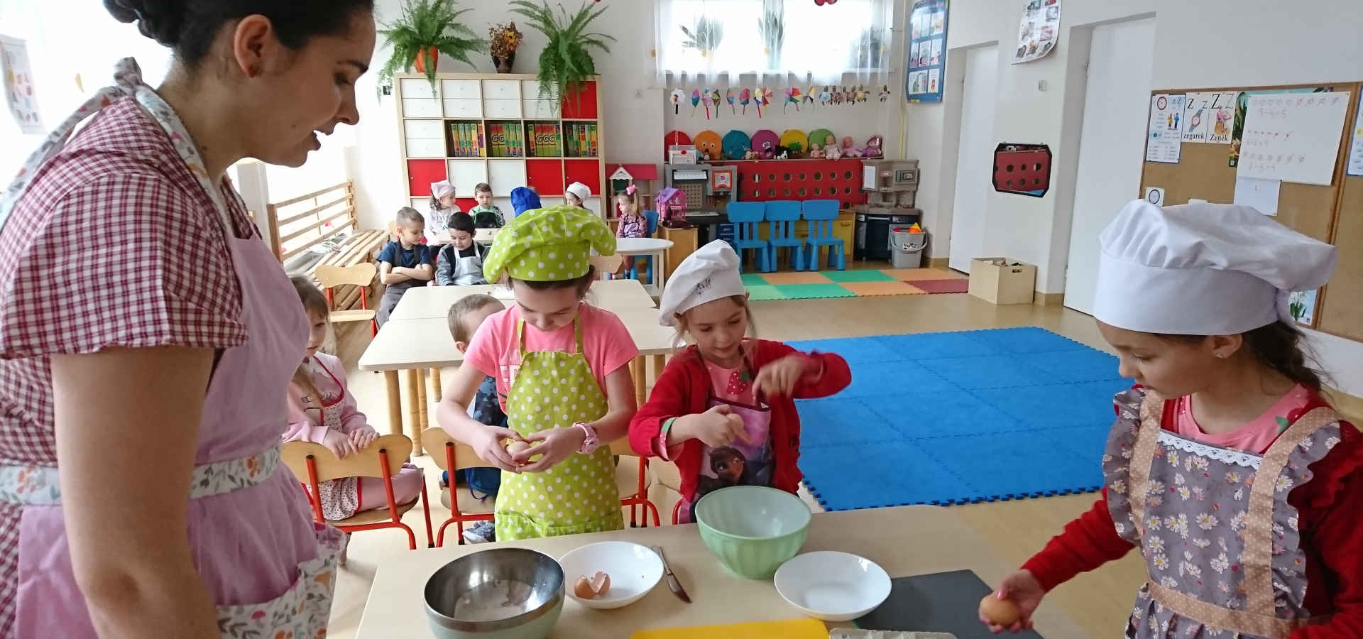 Opiekunka z dziećmi podczas prac kuchennych